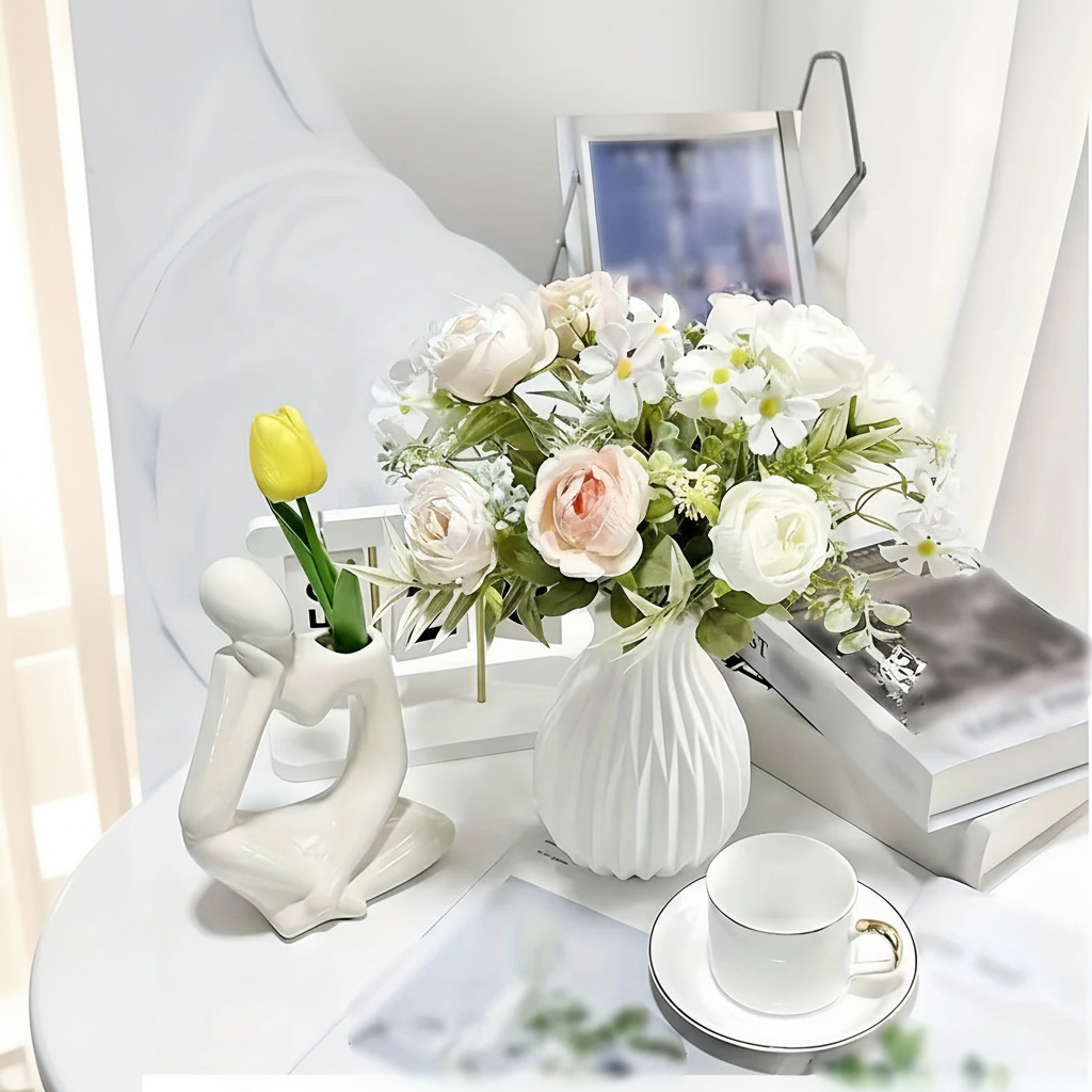 Modern minimalist ceramic vase with fresh flowers on dining table